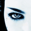 A monochrome blue-toned animated sequence showing a face with dark eye makeup and the text "bring me to life" in four