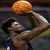 Animated sequence showing a basketball player holding an orange ball above his head against a dark background.