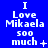 Blue background with white pixelated text reading "I Love Mikaela 500 much" and varying symbols below the text across three