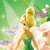 Pixelated image of a blonde fairy character with large wings, green dress, and brown shoes standing among flowers in a green background.