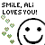 Pixelated text reads 'SMiLE, ALi LOVES YOU!' above a large smiley face and scattered green pixel hearts.