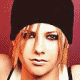 Animated sequence of a person with light brown hair wearing a black beanie and white tank top, showing facial expression changes from neutral to smiling against a pinkish background.