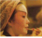 A 5-frame contact sheet showing a person in traditional East Asian theatrical makeup and costume performing sequential actions with hands near the face, including applying or adjusting makeup and manipulating hair accessories.