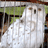 Static 48x48 pixel icon showing a white ghost-like figure with vertical stripes against a blurred green and brown background, rendered in low-resolution pixel art style.