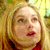 Static 50x50 pixel icon showing a close-up of a person with blonde hair and red lips against a yellow-toned background, rendered in low-resolution pixel art style.