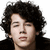 Pixelated close-up of a person with dark curly hair, light skin, and closed eyes against a white background.