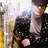Pixelated image of two figures in dark clothing against a bright background with yellow and blue tones.