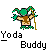 Pixel art character with green hair and hat, brown torso, dark blue pants, holding a golden staff against gray background.