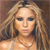 Pixelated close-up of a person with light brown hair, wearing a light-colored top and a thin necklace, against a blurred background.