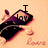 A pixelated image of a dark purple and black object with red accents, featuring text that changes from 'I play' to 'music' above it on an orange background.
