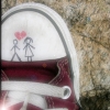 A static icon shows a white sneaker with a red sole, featuring two stick figures holding hands under a red heart symbol.