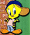 Pixelated yellow cartoon bird with blue cap, light pink shirt, and gray pants standing against green background with brick wall on left side.