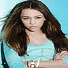 Two side-by-side static images of a woman with long brown hair, one in a light blue top with arms crossed, the other in a white collared shirt smiling.