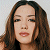 A 50x50 pixel buddy icon split into two frames showing a woman's face on the left and green text on a dark background on the right, with visible pixelation and dithering effects.