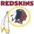 Red text 'REDSKINS' above a circular emblem with yellow border, featuring Native American profile and feathered headdress on white background.