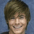 A pixelated image of a person with brown hair against a blue background, overlaid with bright yellow text in pink lettering.