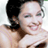 Static 48x48 pixel icon of a person with dark hair tied back, wearing a strapless outfit and smiling against a light background.