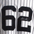 Black numerals '62' on a striped background, with visible pixelation and partial gray overlay in the lower right.