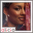 Pixelated portrait of a person with dark skin tone, pink hair, and silver earrings, with the name 'alicia' in pixelated text below.