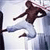 Pixelated static image of a person in mid-kick martial arts pose wearing white pants and dark top against light background with visible dithering and compression artifacts.
