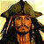 Pixelated image of a person with long dark hair wearing a wide-brimmed brown hat and an orange shirt against a light yellow background.