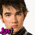 A pixelated image of a person with dark hair and light skin, wearing a black-and-white striped shirt against a white background.