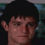 A pixelated image of a person with dark hair in three variations showing different facial expressions against a blurred background.