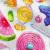 A colorful animated icon featuring a of fruit slices and candies with changing text overlays