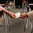 Pixelated image with brown background showing two hands exchanging a white object, pink text reading 'you are the reason', and additional text below.