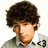 Pixelated image of a person with dark curly hair, light skin, and a beard wearing a collared shirt under a jacket.