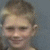 Four distinct profile images arranged in a , each showing a child's face with varying hair colors and expressions against solid backgrounds