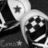 Black-and-white pixelated image of a stylized character with a large head, star-shaped eye, and circular patterns on the body.