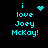 Pixelated cyan text on black background reads "i love Joey McKay!" with four distinct animated heart symbols replacing the word "love" in sequence.