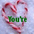 A heart-shaped arrangement of red-and-white striped candy canes on a light blue background with green text reading "You're the only thing on my wishlist".