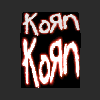 A 3D cube with red neon-style text 'Korn' on black faces, rotating through multiple angles against a dark background.