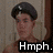 Pixelated image of a person with dark hair wearing a black beret, standing against a muted background with visible text "Hmph." at the bottom.