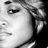 Black-and-white pixelated image of a person's face with text elements including "(Absolute)", "Sip sum'n 100 PROOF", and "RINA" with star symbols.