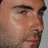 Pixelated close-up of a man's face with stubble, next to blue pixelated text reading 'Adam Noah Levine' and 'Rockin' The Stage! I Luv Maroon 5'.