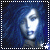 Pixelated blue-toned image of a person with long hair, two star symbols at bottom corners, and white dotted border.