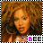 A pixelated image of a person with voluminous curly brown hair and large hoop earrings, wearing a light-colored top with a patterned design, with text 'BEE' below.