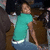 A person in a teal shirt and blue jeans sits with legs bent, head turned right, while green text 'Me' appears over the torso.