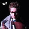 A person in a gray jacket and maroon shirt appears across three of text: 'me?', 'i'm here.', and 'nowhere.' with vertical glitch lines