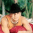 Pixelated image of a person in a black cowboy hat and sleeveless top, with text on a red background reading "no one can make me cry, make me laugh or make me smile like kenny does <3".