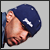 Pixelated static image of a person wearing a dark blue cap with white star, partially visible face showing closed eyes and pink lips against light gray background.