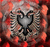 Static pixelated icon with central black and gray eagle silhouette against red-orange gradient background.