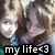 Two pixelated figures in close proximity with a black banner displaying 'my life' and a heart symbol at the bottom.