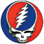 Static circular icon featuring a stylized skull with red and blue color scheme, white lightning bolt design on the head, and pixelated edges against gray background.