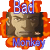 Pixelated image with blue text 'Bad' above and 'Monkey' below a central character portrait surrounded by orange flame-like shapes.