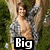 A pixelated image of a shirtless man with a gray patterned jacket, arms raised, standing in front of a tree and greenery, with text overlays.