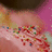 Pixelated image of a hand with colorful sprinkles on pink and yellow background, accompanied by text labels.